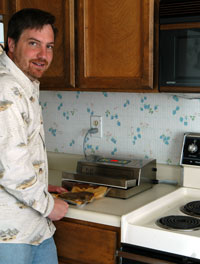 Roger Seher at the counter with his vacuum sealer